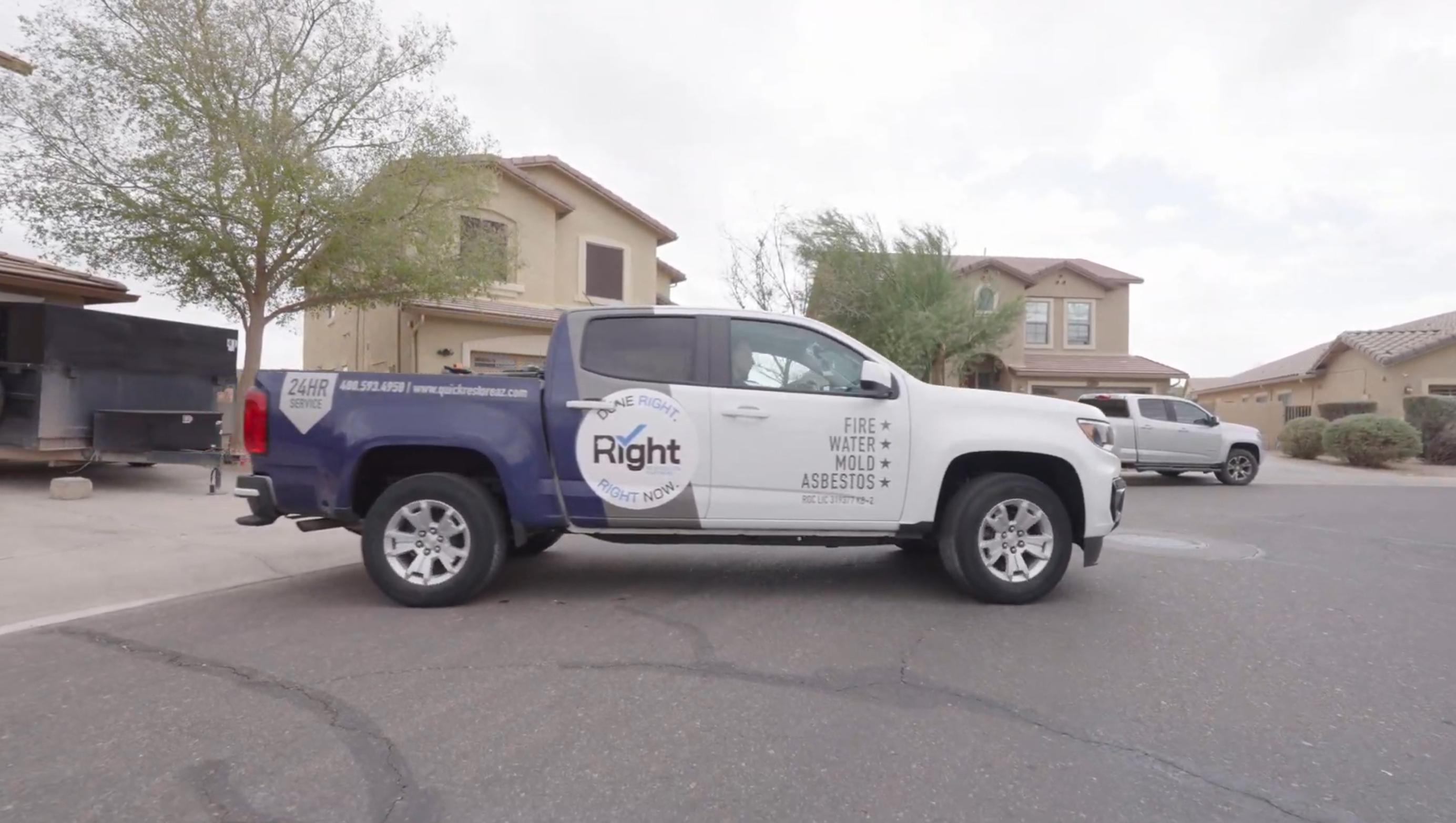 Restoration service truck parked on a residential street.