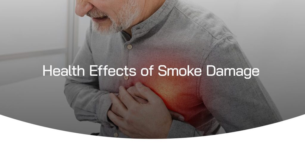 man holding his chest as he is experiencing difficulty breathing due to smoke damage