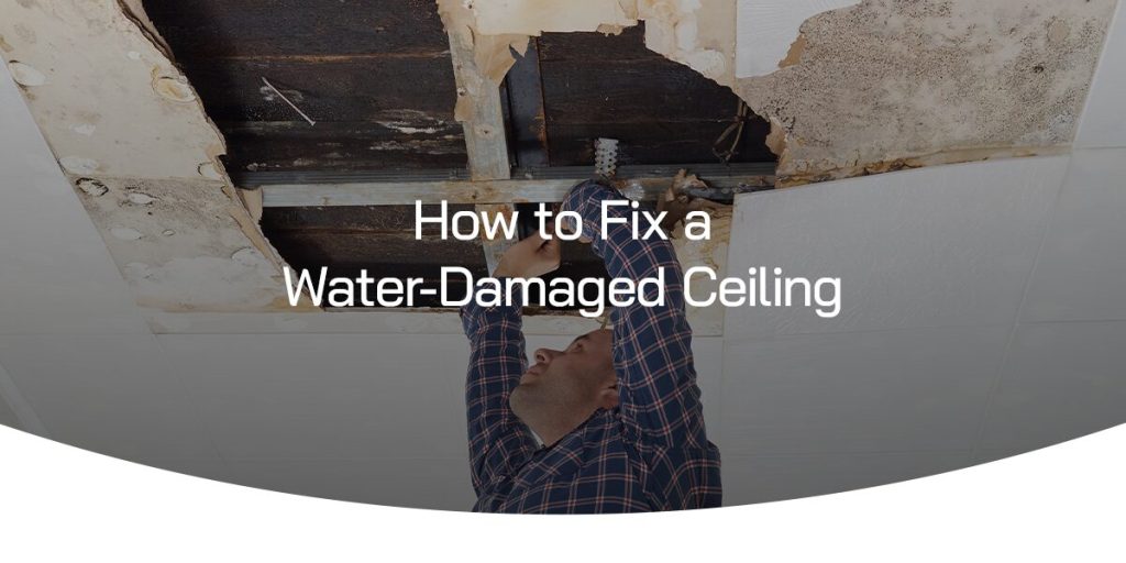 man fixing a water damaged ceiling